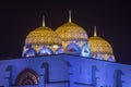 Al Ameen City Mosque glowing at night purple and yellow in Muscat, Oman Royalty Free Stock Photo