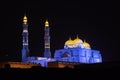 Al Ameen City Mosque glowing at night purple and yellow in Muscat, Oman Royalty Free Stock Photo