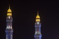 Al Ameen City Mosque Minarets glowing at night purple and yellow in Muscat, Oman Royalty Free Stock Photo