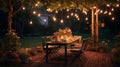 An al fresco dining area in a garden, fairy lights twinkling above. Royalty Free Stock Photo