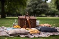 al fresco lunch in the park, with a bagged picnic and blanket