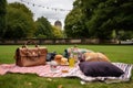 al fresco lunch in the park, with a bagged picnic and blanket