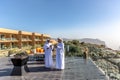 Al Jabal, Oman - Jan 22nd 2018 - Two mans dressing traditional arabic clothes in front of a hotel and a nice landscape in Oman.