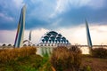 Al Jabbar Great Mosque at sunset (golden hour) with lamps and reflections in the pond