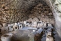 Fragments of stone columns and stone tools in the courtyard of the medieval fortress Ash Shubak, standing on a hill near Al Jaya c