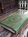 The holy Qur'an with wooden house background