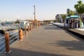Al Seef new modern area at Bur Dubai with restaurants, cafes and marina with yachts empty. Wooden promenade in Dubai Deira