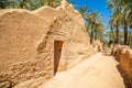 Al Ula ruined old town street with palms along the road, Saudi Arabia