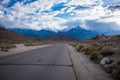 Alabama Hills Recreation Area in Lone Pine California - road through the area with weird rocks and boulders. An approaching storm Royalty Free Stock Photo