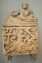 Alabaster cinerary urn with the figure of a man reclining on the lid and a carved panel on the chest at the British Museum