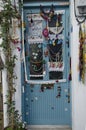 Alacati has a wonderful village gate, decorated with scarves, lace, classic blue painted door Royalty Free Stock Photo