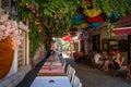 Alacati, Izmir, Turkey - August 25 2021: Tables set up on the narrow cobbled streets of Alacati are waiting for tourists Royalty Free Stock Photo