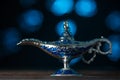 Aladdin`s magical genie lamp on soft blue lights background. Lamp of wishes concept. Antique arabian style