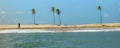 Alagoas/Brazil - Apr.13.19: man walks on the beach with four palm trees