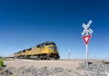 Alamogordo, NM / United States - July 10, 2016: Union Pacific freight train crosses a railroad crossing in the New Mexico desert o Royalty Free Stock Photo