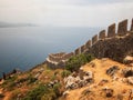 Alanya Castle fortress wall and Mediterranean Sea in Alanya harbor. Alanya, Antalya, Turkey Royalty Free Stock Photo