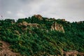 Alanya Castle Turkey on the top of a mountain among a green forest - bottom view. Ancient fortress with a tower and stone walls Royalty Free Stock Photo