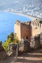 Alanya fortress walls on a rocky peninsula. View of the city beach Cleopatra. Turkey Royalty Free Stock Photo