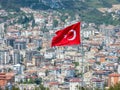 Alanya, Turkey - Apr 26, 2023. The Turkish flag proudly flying over Alanya city Royalty Free Stock Photo