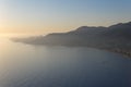 Alanya, Turkey - August, 8, 2019: View to the Alanya Deniz Feneri Alanya lighthouse from the beach.  People relax on the Mediter Royalty Free Stock Photo