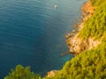 Alanya, Turkey. Beautiful top view from the fortress Alanya Castle of the Mediterranean Sea, cliffs and boat at sunset. Vacation Royalty Free Stock Photo