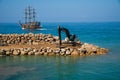 Excursion pirate yacht left the harbor. Many tourists set sail on a ship in a calm blue sea. The blue cloudless sky Royalty Free Stock Photo