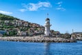 Panorama of Alanya with a white old lighthouse on the background of modern cottages on a Royalty Free Stock Photo