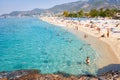 Alanya, Turkey - September 14, 2017: Tropical sea beach with swimming tourists on summer vacation resort.