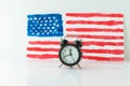 Alarm clock and abstract hand drawn American flag on background. President elections, Memorial Day, 4th of July or Labour Day Royalty Free Stock Photo