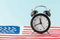 Alarm clock on abstract hand drawn American flag on background. President elections, Memorial Day, 4th of July or Labour Day Royalty Free Stock Photo