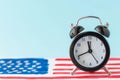 Alarm clock on abstract hand drawn American flag on background. President elections, Memorial Day, 4th of July or Labour Day Royalty Free Stock Photo