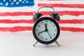 Alarm clock and abstract hand drawn American flag on background. President elections, Memorial Day, 4th of July or Labour Day Royalty Free Stock Photo