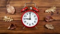 Alarm clock and autumn leaves, back to school, fall background