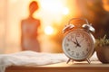 Alarm clock on bedside table in bedroom with woman sleeping on bed in blurred background. Generative AI Royalty Free Stock Photo