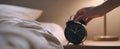The alarm clock on the bedside table capturing morning tranquility..AI generated image Royalty Free Stock Photo