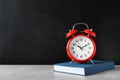 Alarm clock with book on table Royalty Free Stock Photo