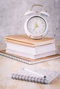 Alarm clock and books - time management and procrastination concept Royalty Free Stock Photo