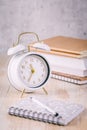 Alarm clock and books - time management and procrastination concept Royalty Free Stock Photo