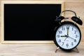 Alarm clock and chalkboard or blackboard for your text show board plan with time and Back to school concept. Royalty Free Stock Photo