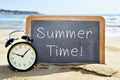 Alarm clock and chalkboard with the text summer time Royalty Free Stock Photo