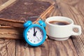 Alarm clock with coffe cup and vintage books Royalty Free Stock Photo