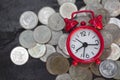 Alarm clock and coins on wooden table, Money savings, Investment, growing concept, Stacking growing coins, Saves money for the Royalty Free Stock Photo