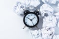 Alarm clock with crumpled paper balls.Timing and thinking idea concept Royalty Free Stock Photo