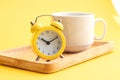 Alarm clock and cup of coffe on wooden table Royalty Free Stock Photo