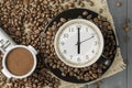 Alarm clock in a cup of coffee. Photo creative