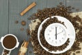 Alarm clock in a cup of coffee. Photo creative