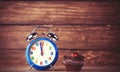 Alarm clock and cupcake. Royalty Free Stock Photo