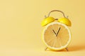 Alarm clock with a cut lemon fruit instead of the clock face. Summer time, welcome summer. Creative minimal concept, vitamins, Royalty Free Stock Photo