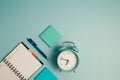 An alarm clock with a diary notebook and others work and educational materials Royalty Free Stock Photo