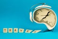 Alarm clock is distorted, travel concept during pandemic, composition with word on blue isolated background, copy space